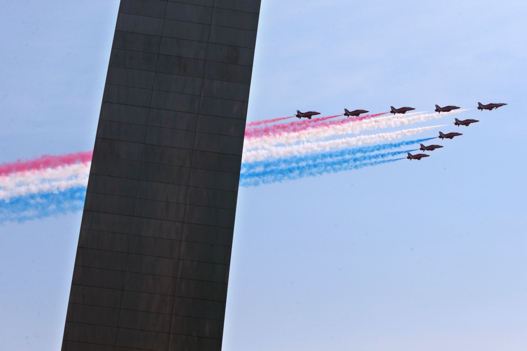 UK's Royal Air Force Red Arrows fly over the Arch